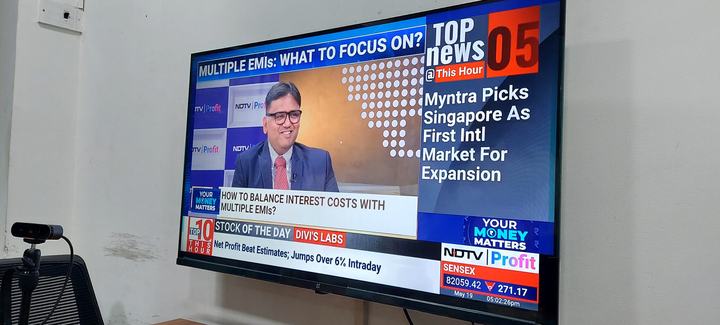 The GYR team at the office, watching Rohit Shah appear live on NDTV Profit on a television screen.