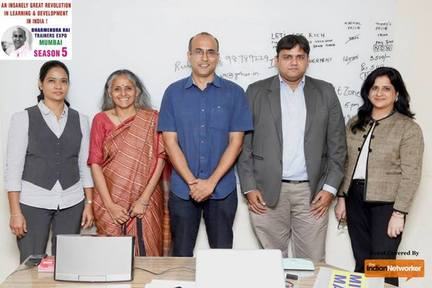 Rohit Shah stands with four other speakers in front of a whiteboard at the L&D Training Expo, Season 5.