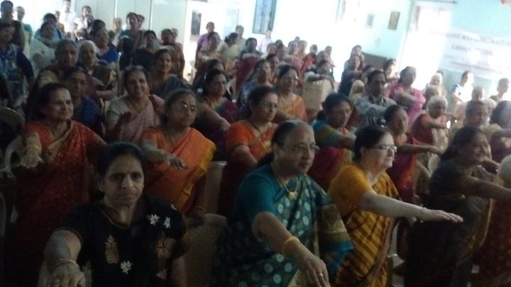 A large audience of women seated together during a talk.