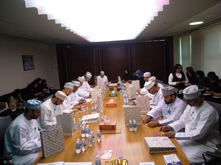 Participants seated around a long conference table during a workshop.